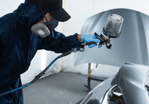 How does the HVLP technology improve the performance of automatic spray guns?